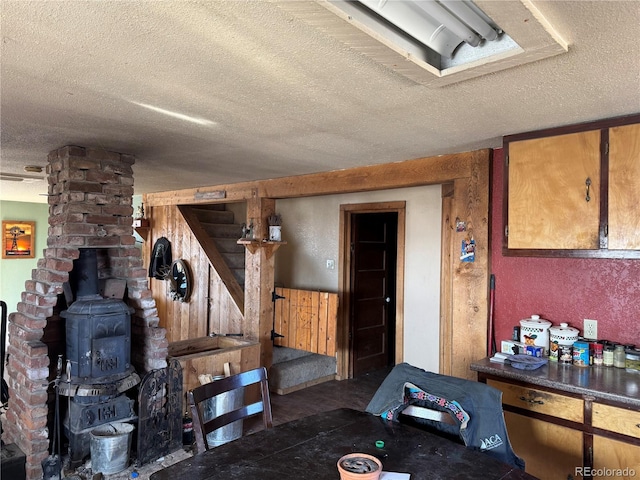 miscellaneous room with a textured ceiling and wood walls