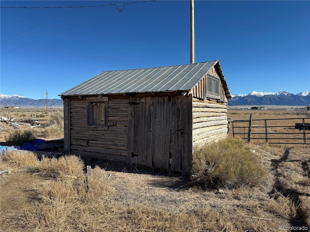 view of outbuilding featuring a mountain view and a rural view