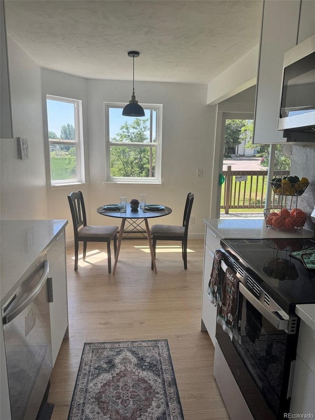 17361 E Mansfield Ave Unit 521R, Aurora, CO 80013 - dining space with light wood-style floors and baseboards