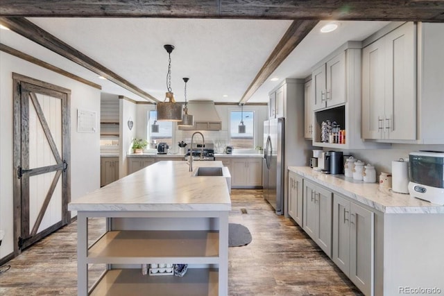 kitchen with freestanding refrigerator, light countertops, gray cabinetry, and open shelves