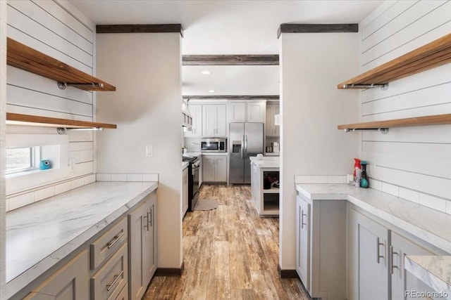 kitchen featuring stainless steel appliances, gray cabinets, light countertops, and open shelves