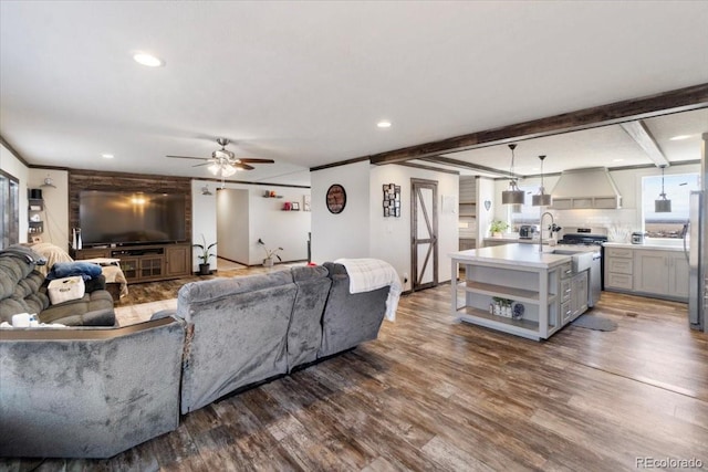 living room featuring recessed lighting, beam ceiling, ceiling fan, and wood finished floors