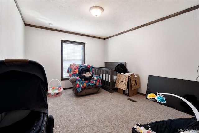 carpeted bedroom featuring a textured ceiling, baseboards, and crown molding