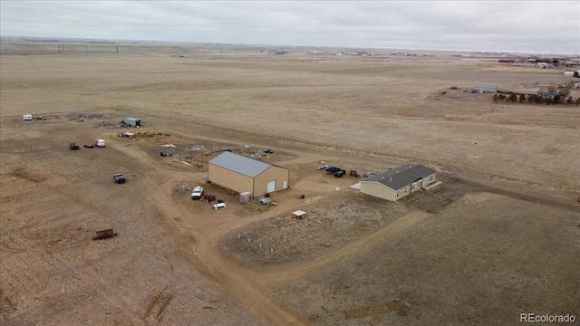 birds eye view of property with a rural view