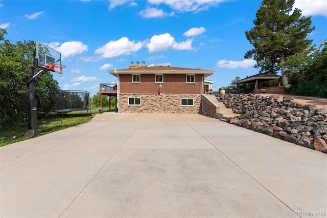 1380 Oak Valley Rd, Sedalia, CO 80135 - view of side of property with a trampoline and a wooden deck