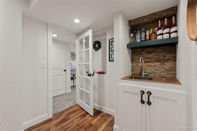1380 Oak Valley Rd, Sedalia, CO 80135 - indoor wet bar featuring wood finished floors, french doors, and recessed lighting