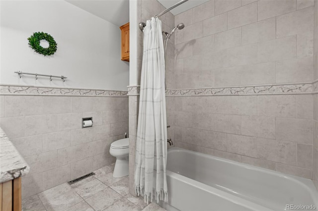 1380 Oak Valley Rd, Sedalia, CO 80135 - full bathroom featuring shower / tub combo, tile walls, vanity, and a wainscoted wall