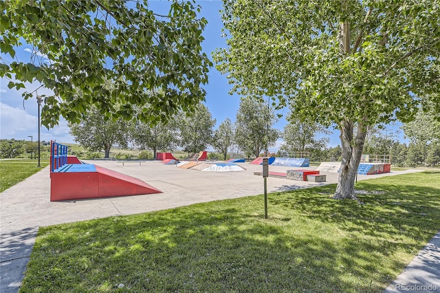 view of property's community with a pool, a patio area, and a yard