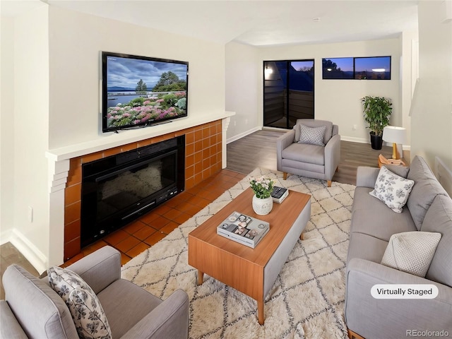 living room featuring a tile fireplace