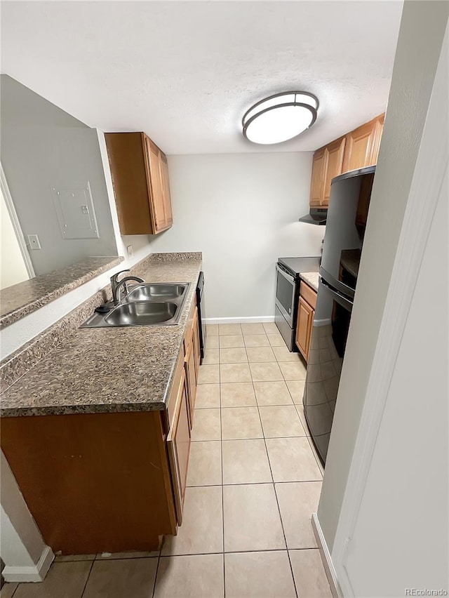 kitchen featuring light tile patterned flooring, black refrigerator, ventilation hood, sink, and stainless steel range with electric stovetop