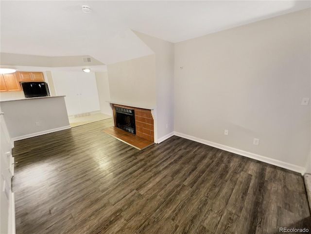 unfurnished living room with dark hardwood / wood-style flooring