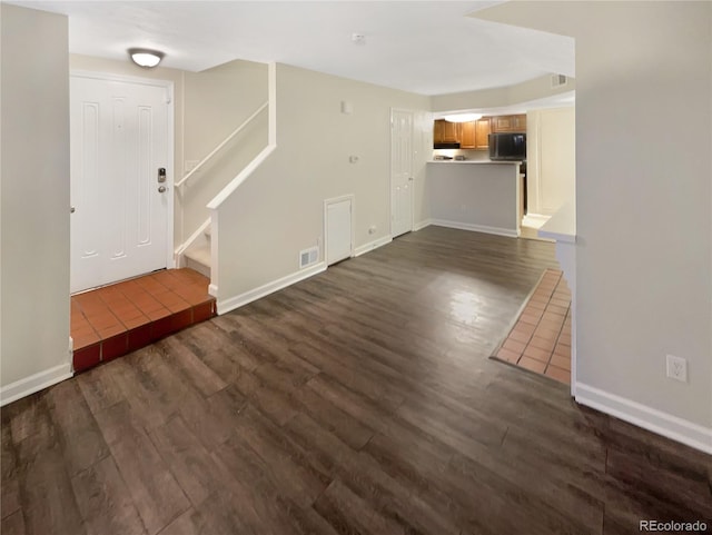 unfurnished living room featuring dark hardwood / wood-style floors