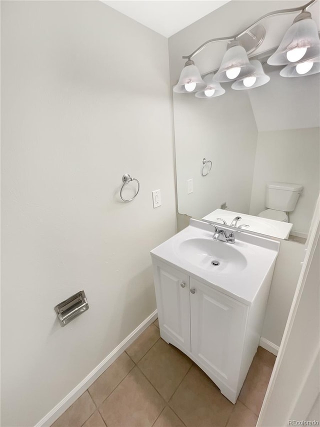 bathroom featuring vanity, tile patterned floors, and toilet