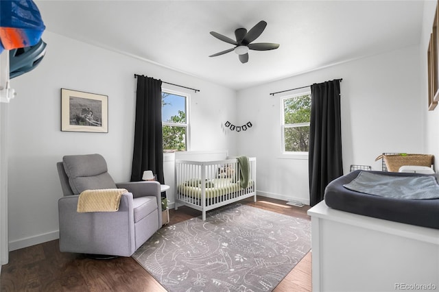 9220 Yucca Way, Thornton, CO 80229 - bedroom featuring multiple windows, wood finished floors, and baseboards