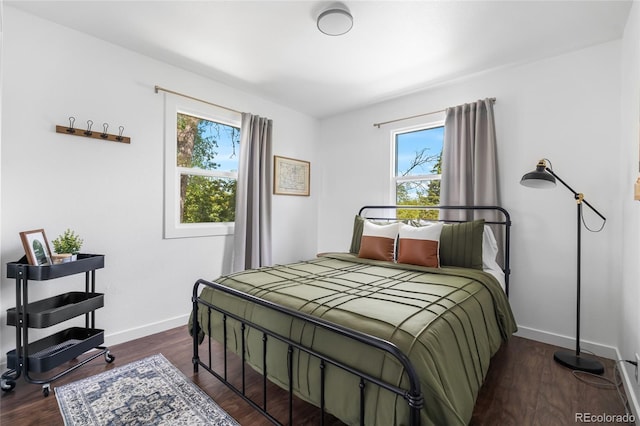 9220 Yucca Way, Thornton, CO 80229 - bedroom featuring multiple windows, baseboards, and dark wood finished floors