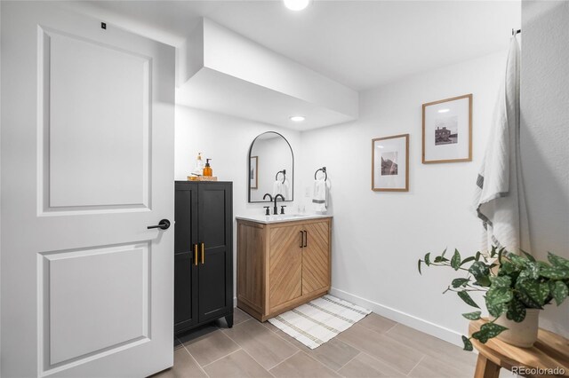 9220 Yucca Way, Thornton, CO 80229 - bathroom featuring vanity, baseboards, and recessed lighting