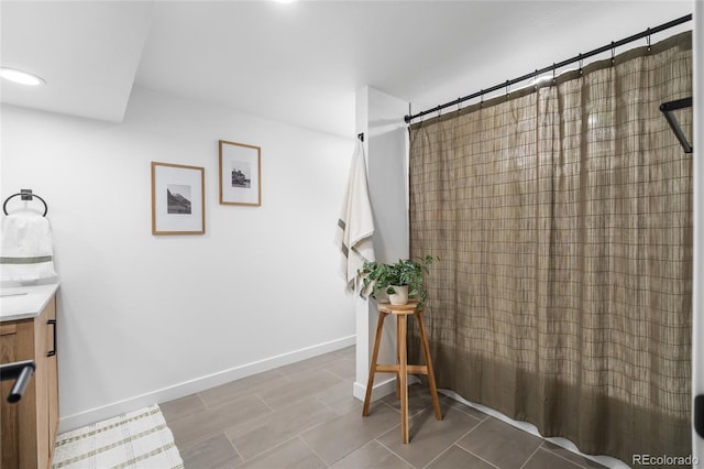 9220 Yucca Way, Thornton, CO 80229 - full bath with vanity, a shower with shower curtain, baseboards, and recessed lighting