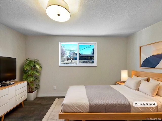 bedroom featuring dark hardwood / wood-style floors and a textured ceiling