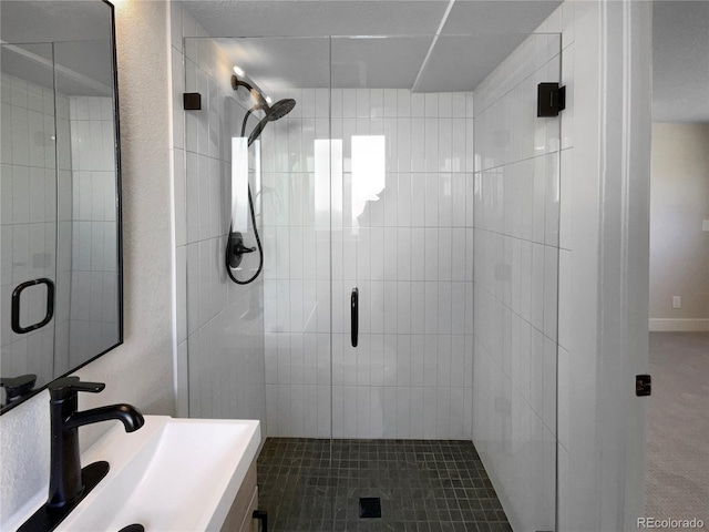 bathroom featuring tile patterned floors, vanity, and a shower with shower door