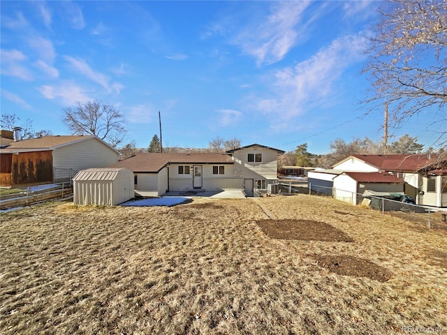 rear view of property with a patio and a shed