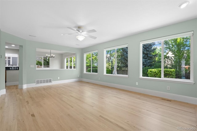 7837 Aravon Ct, Lone Tree, CO 80124 - spare room with plenty of natural light, light wood-type flooring, a chandelier, and baseboards