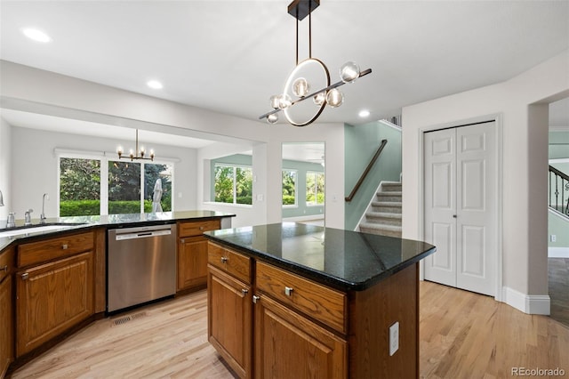 7837 Aravon Ct, Lone Tree, CO 80124 - kitchen featuring dishwasher, a chandelier, a sink, brown cabinetry, and light wood-style floors
