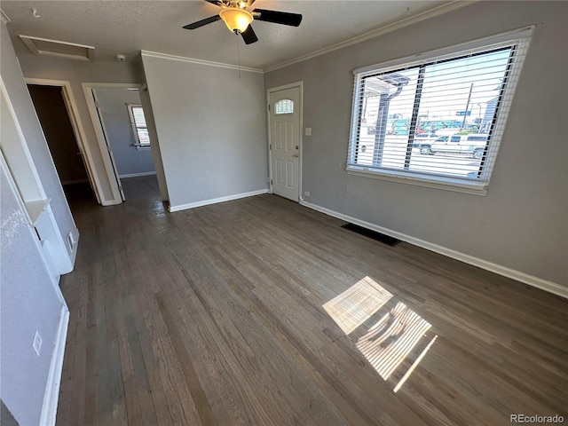 2946 W Park Pl, Denver, CO 80219 - unfurnished living room featuring plenty of natural light, dark wood-type flooring, crown molding, attic access, and ceiling fan