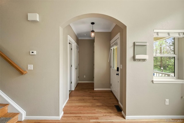 3712 Wolff St, Denver, CO 80212 - corridor with crown molding, arched walkways, light wood-type flooring, stairway, and baseboards
