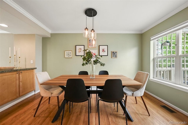 3712 Wolff St, Denver, CO 80212 - dining space featuring light wood-type flooring, crown molding, and baseboards