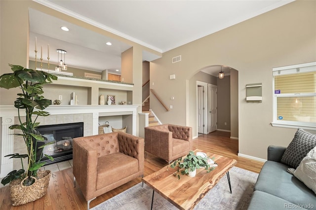 3712 Wolff St, Denver, CO 80212 - living area with arched walkways, baseboards, light wood-style floors, stairs, and crown molding