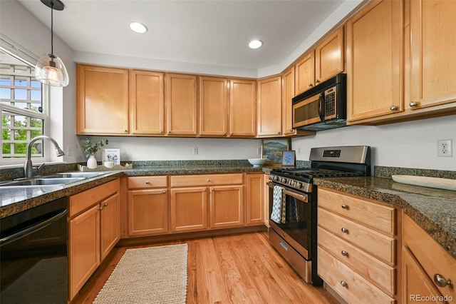 3712 Wolff St, Denver, CO 80212 - kitchen with stainless steel range with gas cooktop, dishwasher, a sink, light wood finished floors, and pendant lighting