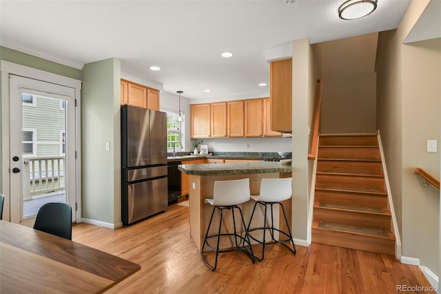 3712 Wolff St, Denver, CO 80212 - kitchen with freestanding refrigerator, a sink, a peninsula, black dishwasher, and a breakfast bar
