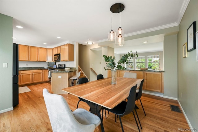 3712 Wolff St, Denver, CO 80212 - dining space featuring ornamental molding, light wood-type flooring, baseboards, recessed lighting, and stairway