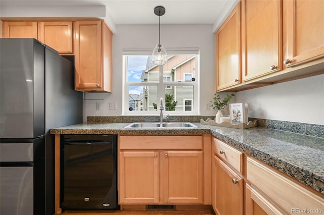 3712 Wolff St, Denver, CO 80212 - kitchen with black dishwasher, a sink, freestanding refrigerator, hanging light fixtures, and light brown cabinetry