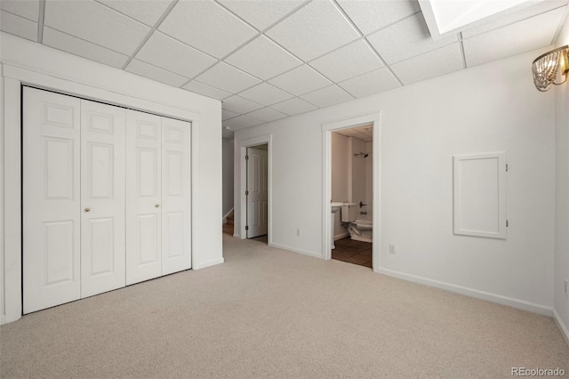 3712 Wolff St, Denver, CO 80212 - unfurnished bedroom with a paneled ceiling, carpet, a closet, baseboards, and connected bathroom