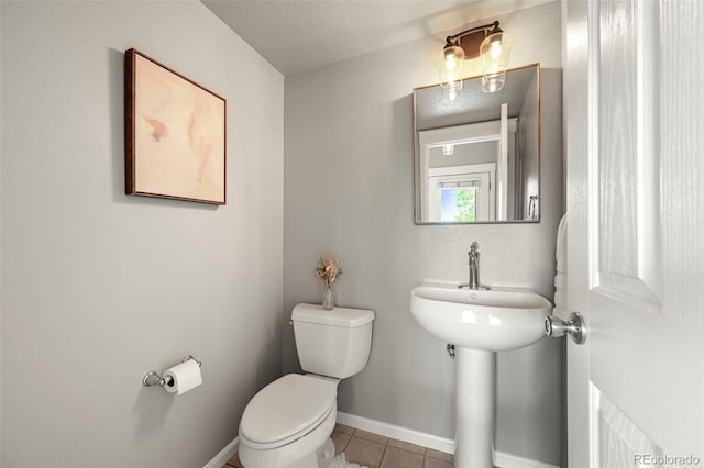 3712 Wolff St, Denver, CO 80212 - bathroom with toilet, tile patterned flooring, and baseboards