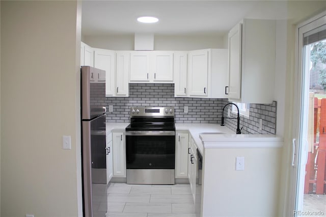 kitchen with decorative backsplash, appliances with stainless steel finishes, white cabinetry, and sink