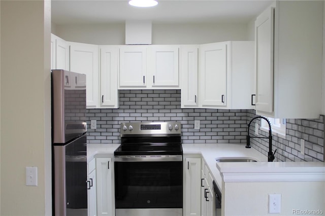 kitchen featuring white cabinets, sink, stainless steel appliances, and tasteful backsplash