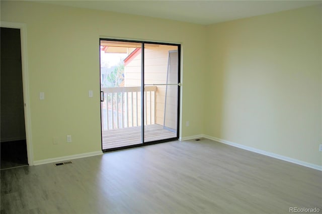 unfurnished room with light wood-type flooring