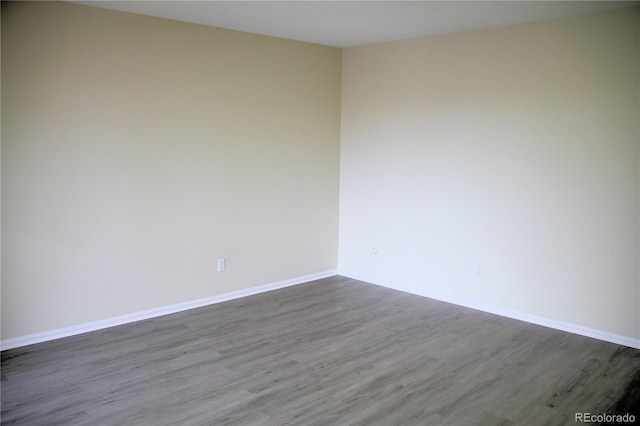 empty room with dark hardwood / wood-style floors