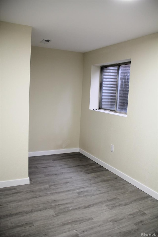 spare room featuring dark hardwood / wood-style flooring