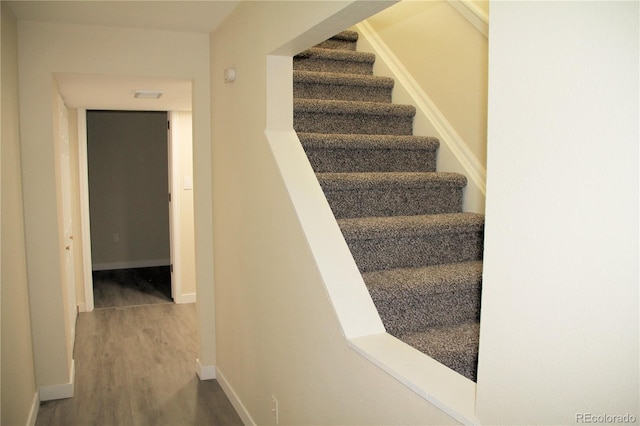 stairs featuring hardwood / wood-style flooring