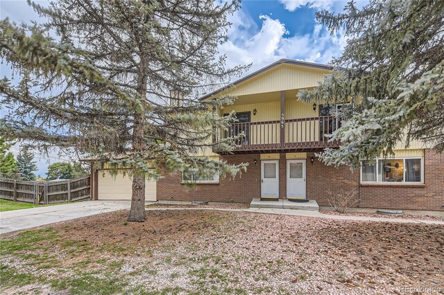 view of front of property with a balcony and a garage