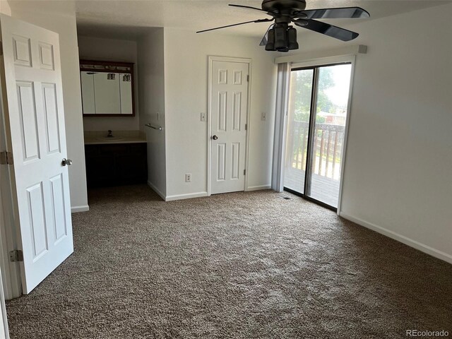 unfurnished bedroom featuring ceiling fan, access to exterior, sink, and carpet