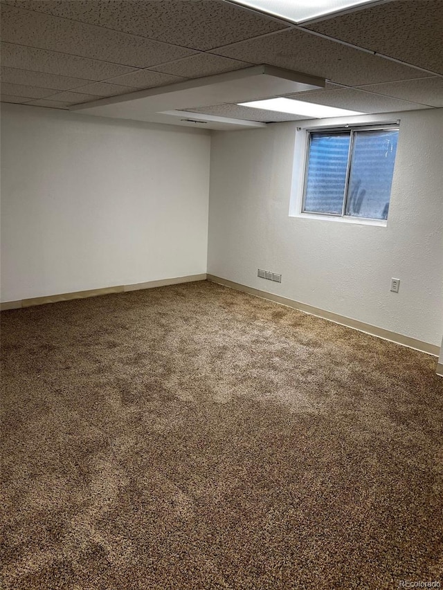 interior space with a paneled ceiling