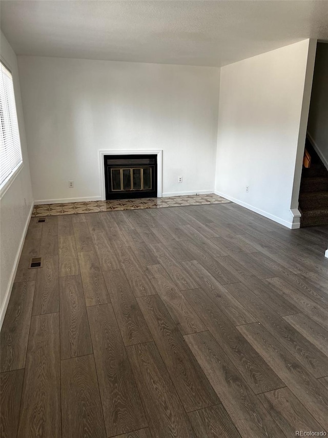 unfurnished living room with dark hardwood / wood-style flooring