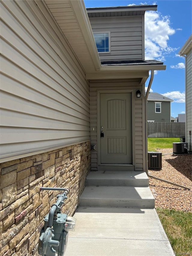 522 Foxtail Pl, Wiggins, CO 80654 - property entrance featuring central AC and stone siding