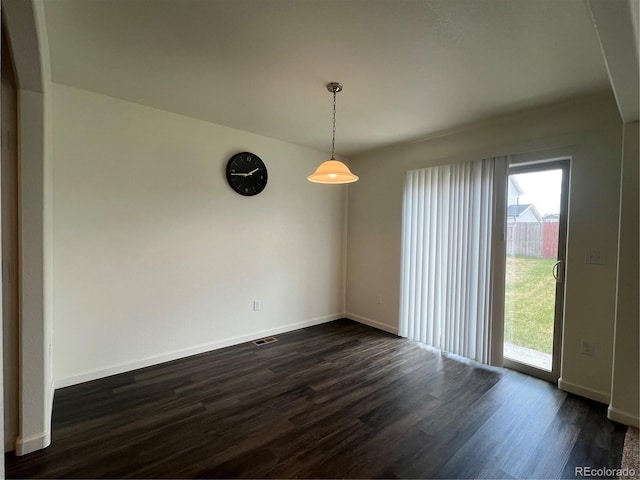 522 Foxtail Pl, Wiggins, CO 80654 - spare room featuring dark wood-type flooring, plenty of natural light, and baseboards