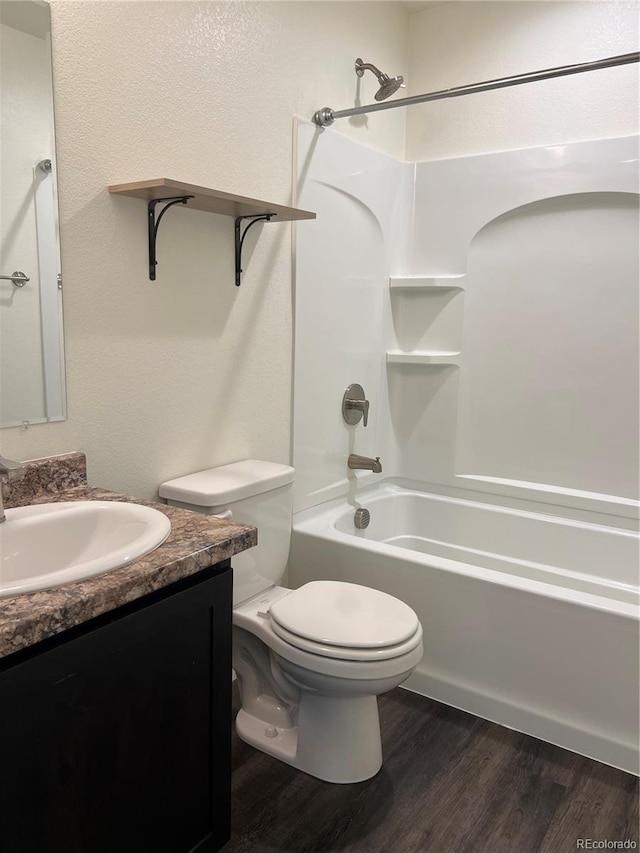 522 Foxtail Pl, Wiggins, CO 80654 - bathroom featuring vanity, toilet, wood finished floors, and shower / bathtub combination