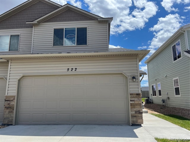 522 Foxtail Pl, Wiggins, CO 80654 - garage with concrete driveway and central air condition unit